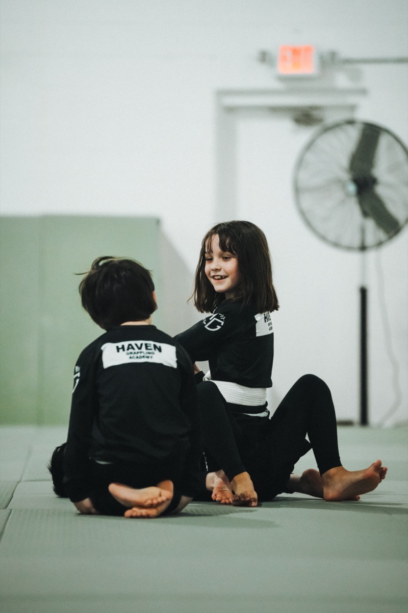 Coach working with a young student at Haven Grappling Academy